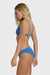 Woman wearing a blue bikini on a white background