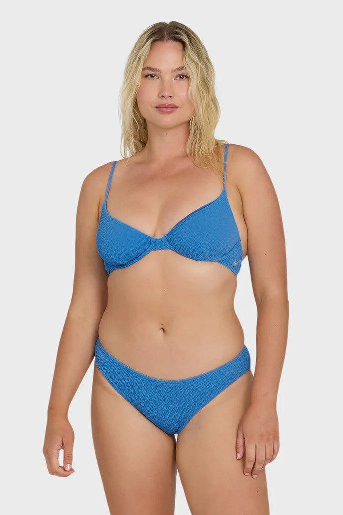 Woman wearing a blue bikini on a white background