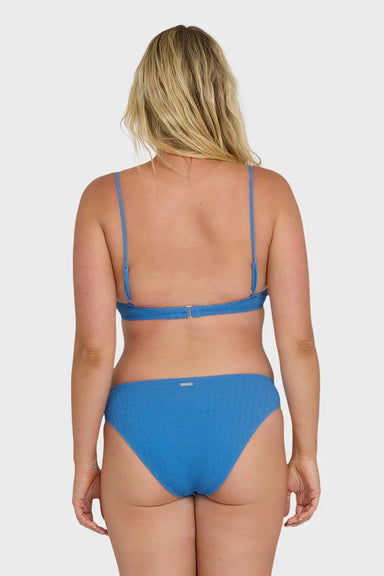 Woman wearing a blue bikini on a white background