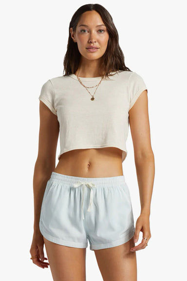 woman wearing a cropped white t-shirt and chambray drawstring shorts