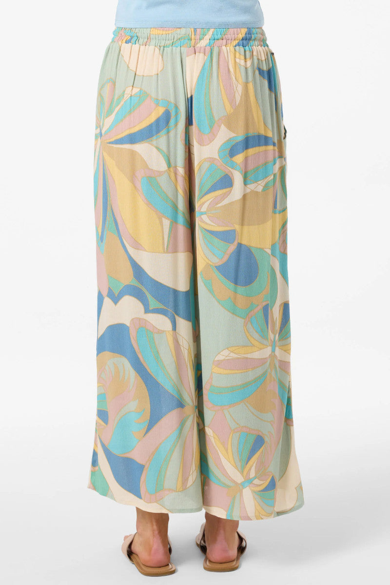 Colorful patterned pants worn by a person on a white background