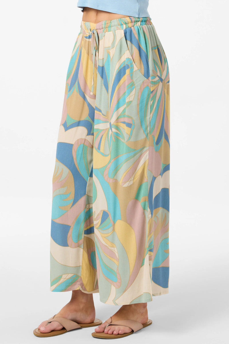 Colorful patterned pants worn by a person on a white background