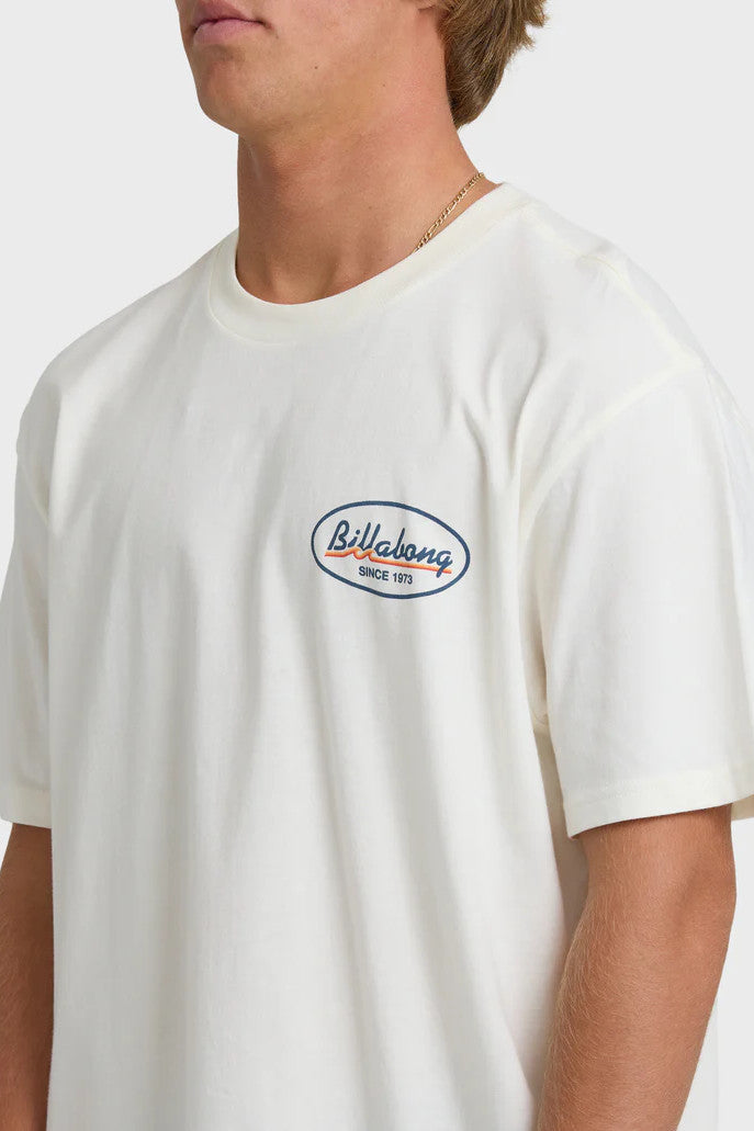 Person wearing a white t-shirt with a Billabong logo