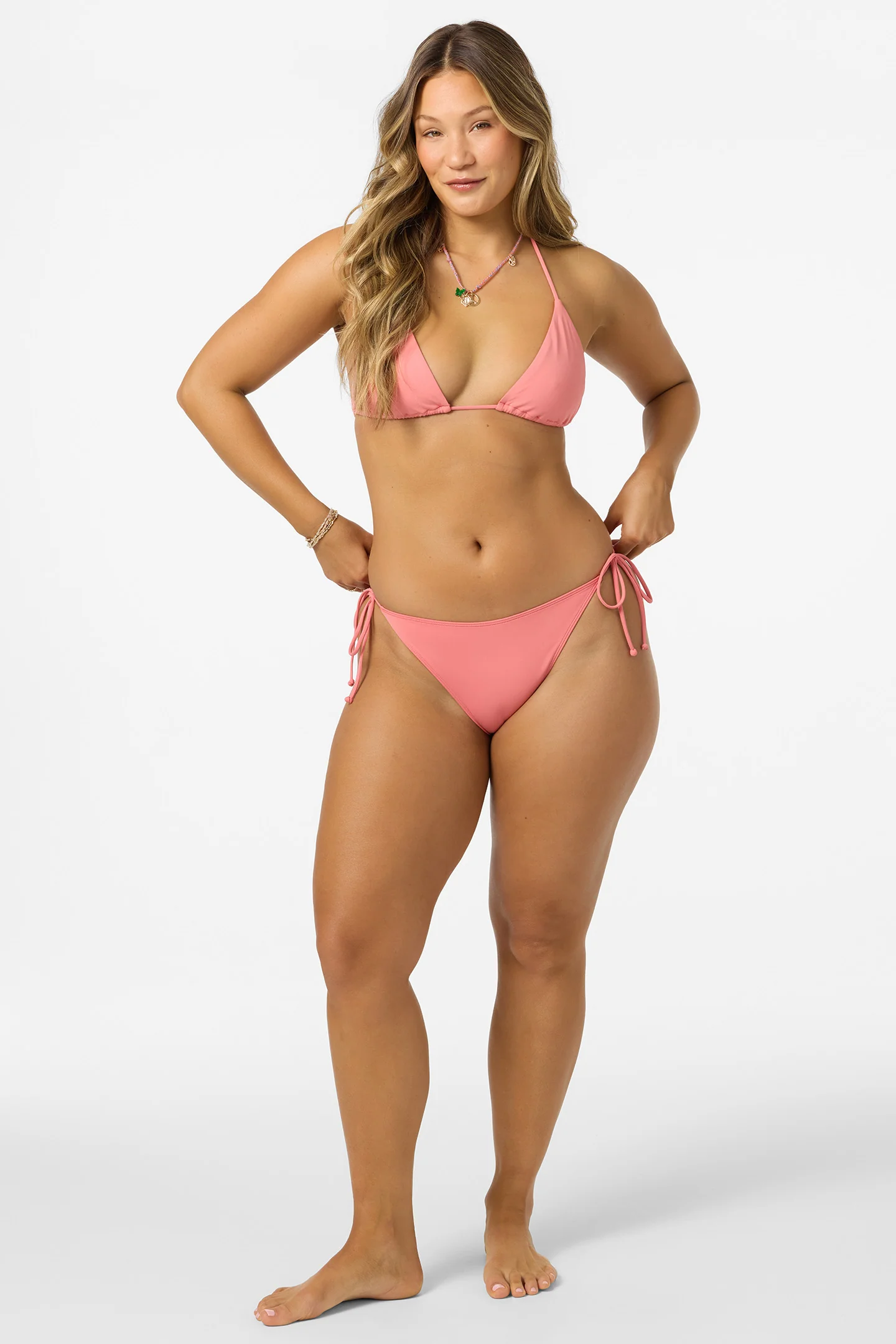 Woman wearing a pink bikini on a white background