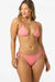 Woman wearing a pink bikini on a white background