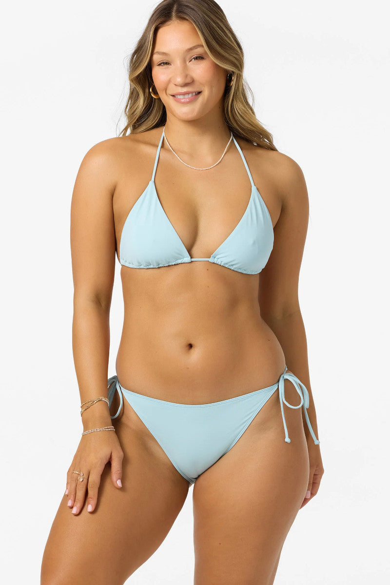Woman wearing a light blue bikini set on a white background