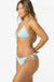 Woman wearing a light blue bikini on a white background