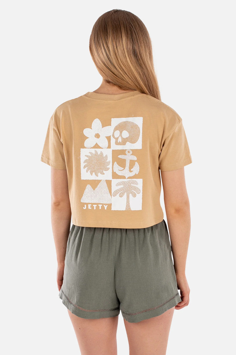 Person wearing a beige t-shirt with white graphics and 'JETTY' branding, standing against a white background.