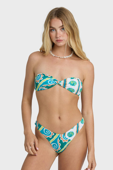 Woman wearing a colorful bandeau bikini with a white background