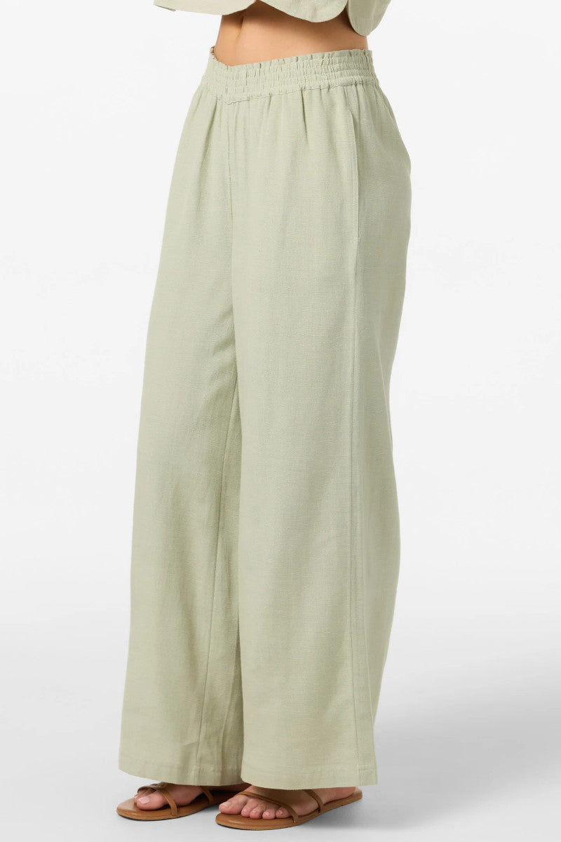 Light green wide-leg pants worn by a person on a white background