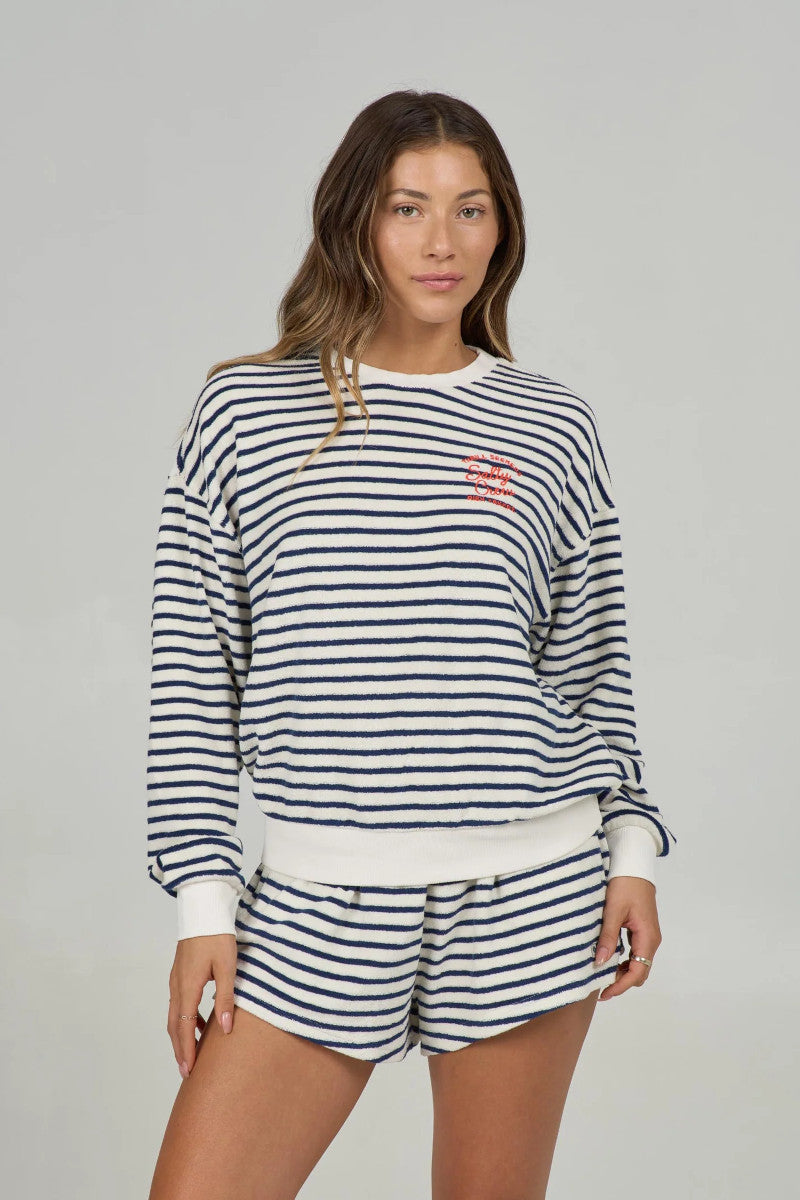 Woman wearing a striped sweatshorts and matching shorts on a gray background