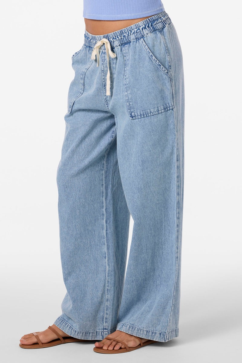 Light blue denim pants worn by a person on a white background
