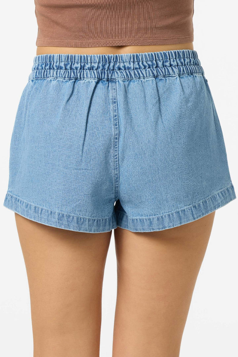 Light blue denim shorts worn by a person on a white background