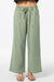 Green wide-leg pants with a tie waist on a white background
