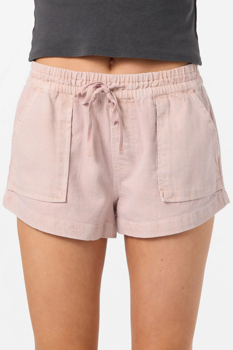 Beige shorts worn by a person on a white background
