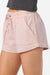 Pink shorts worn by a person on a white background
