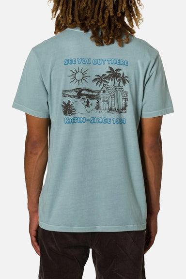 Person wearing a light blue t-shirt with a graphic design and text on the back.
