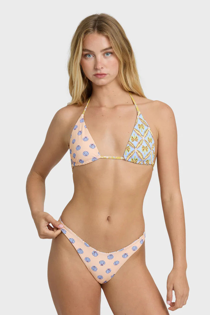 Woman wearing a patterned bikini on a white background