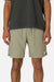 Person wearing green shorts and a black shirt on a white background