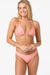 Woman wearing a pink bikini on a white background