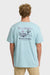 Person wearing a light blue Billabong t-shirt with a graphic design on the back.