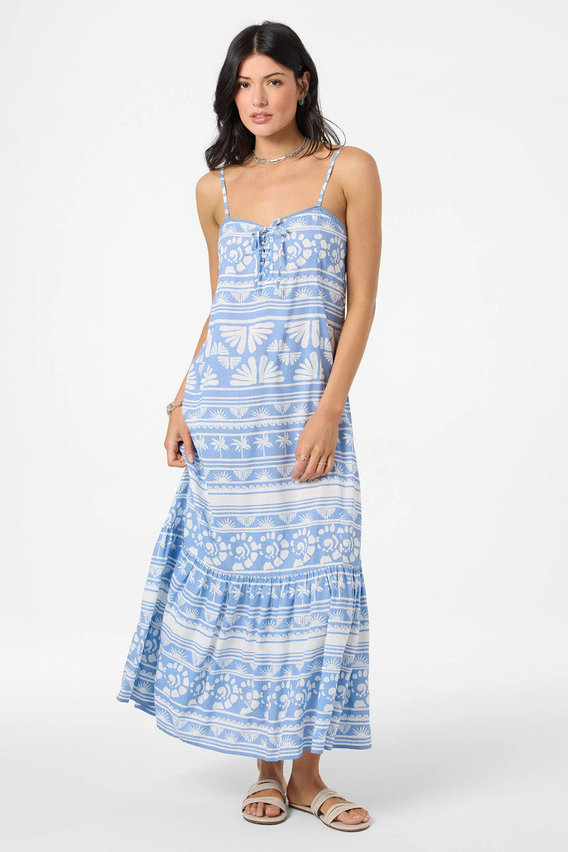 Woman wearing a blue patterned dress on a white background