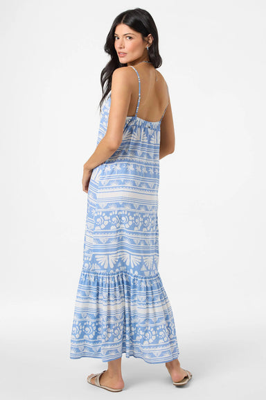 Woman wearing a blue patterned maxi dress on a white background