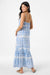 Woman wearing a blue patterned maxi dress on a white background