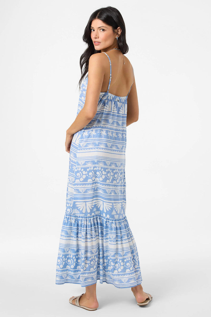 Woman wearing a blue patterned maxi dress on a white background