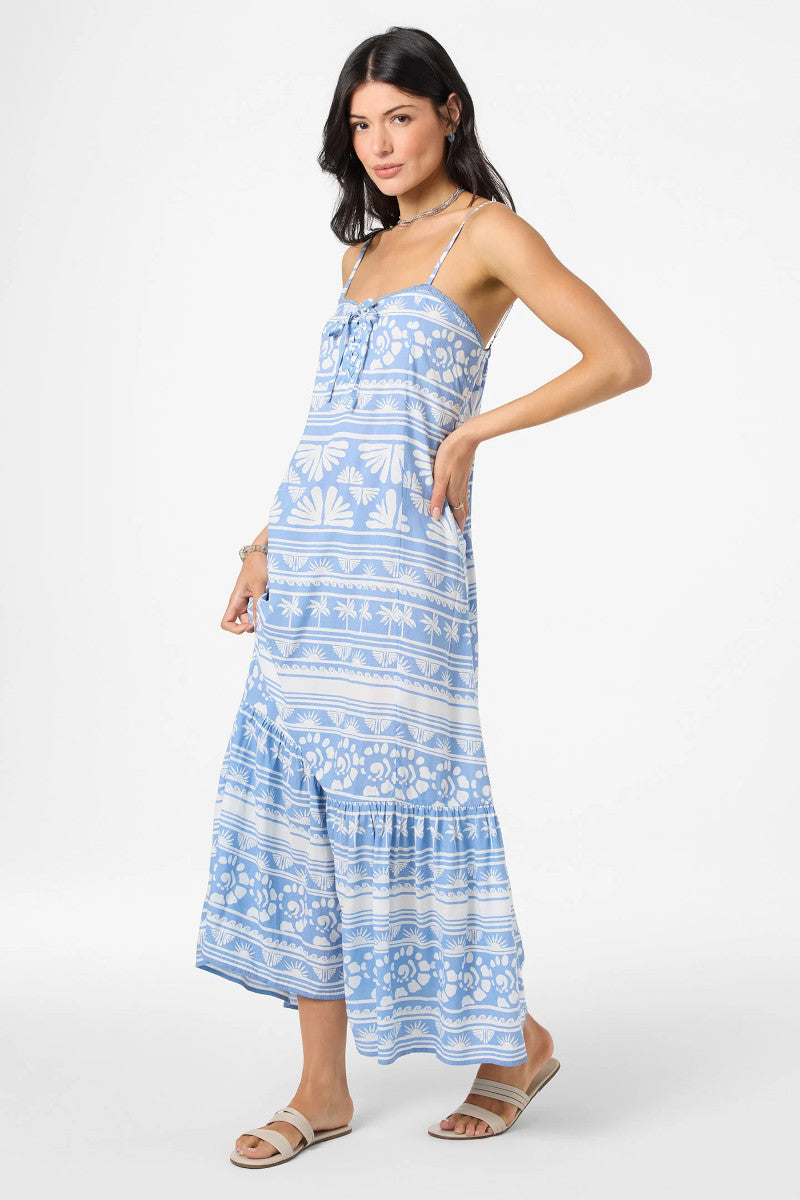 Woman wearing a blue and white patterned dress on a white background