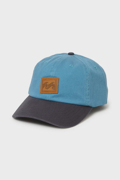 Blue cap with a brown leather patch on a light gray background