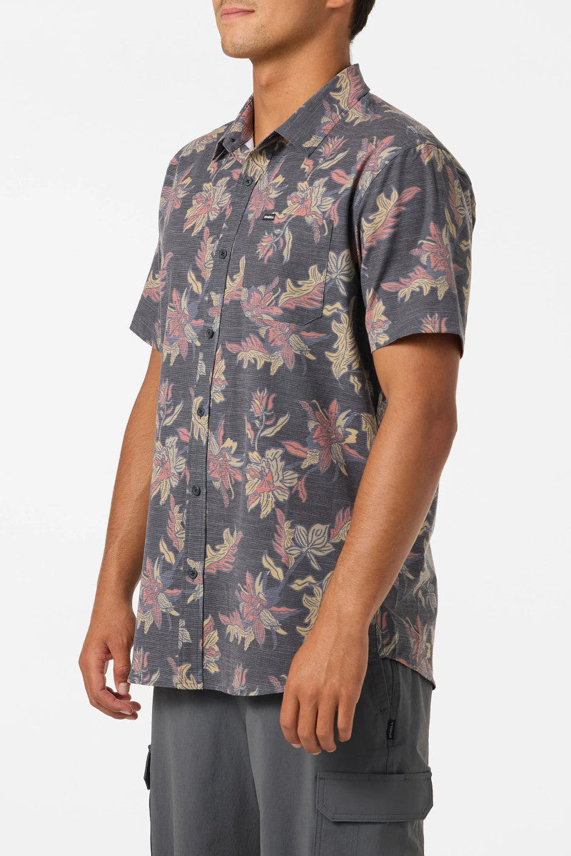Man wearing a floral patterned shirt with a white background