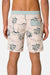 Beige shorts with palm tree pattern worn by a person on a light gray background