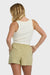 Woman wearing a white tank top and green shorts on a white background